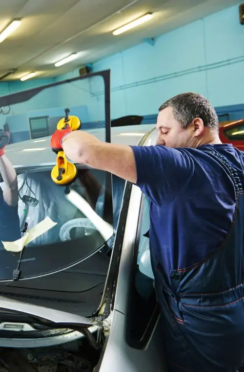 mechanic repairing the windshiled