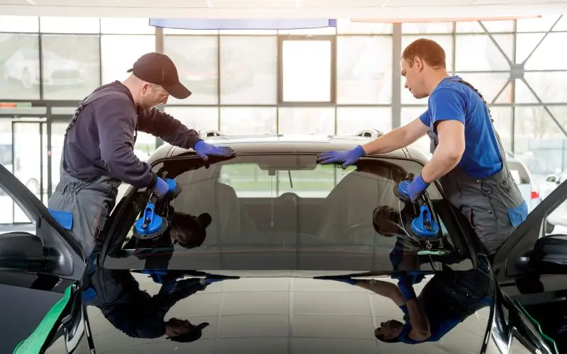 two man working on the windshield