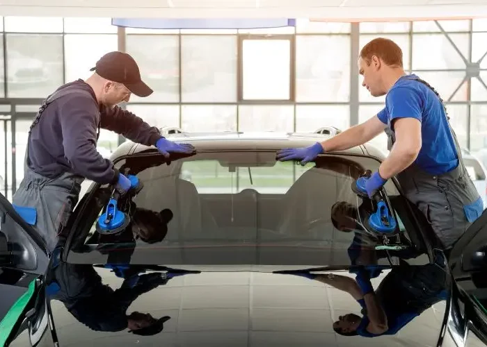 two man working on the windshield